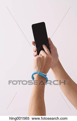 Young Japanese man using smartphone View Large Photo Image Stock Photography - Young Japanese man using smartphone. Fotosearch