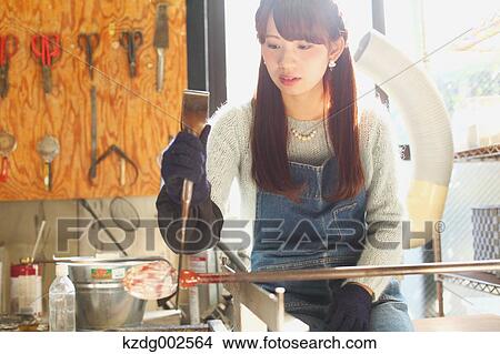 Young Japanese woman enjoying glass crafting workshop in Kawagoe, Japan View Large Photo Image Picture - Young Japanese woman enjoying glass crafting workshop in Kawagoe, Japan. Fotosearch