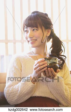 Young Japanese woman enjoying Maccha green tea in Kawagoe, Japan View Large Photo Image Stock Image - Young Japanese woman enjoying Maccha green tea in Kawagoe, Japan. Fotosearch