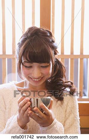 Young Japanese woman enjoying Maccha green tea in Kawagoe, Japan View Large Photo Image Stock Image - Young Japanese woman enjoying Maccha green tea in Kawagoe, Japan. Fotosearch