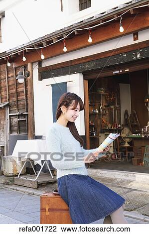 Stock Image - Young Japanese woman enjoying trip in Kawagoe, Japan. Fotosearch