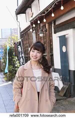 Stock Photo - Young Japanese woman enjoying trip in Kawagoe, Japan. Fotosearch