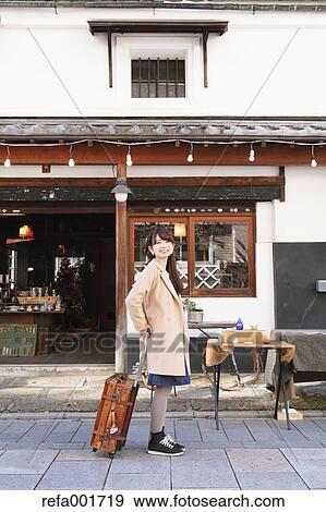 Stock Photo - Young Japanese woman enjoying trip in Kawagoe, Japan. Fotosearch