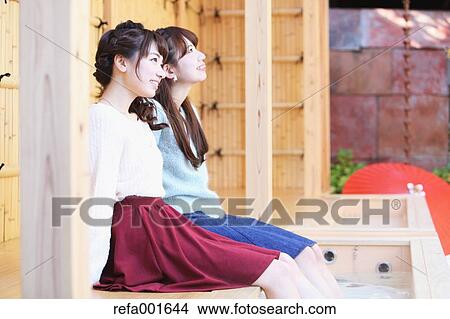 Picture - Young Japanese women enjoying foot spa in Kawagoe, Japan. Fotosearch