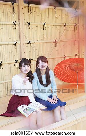 Stock Photo - Young Japanese women enjoying foot spa in Kawagoe, Japan. Fotosearch