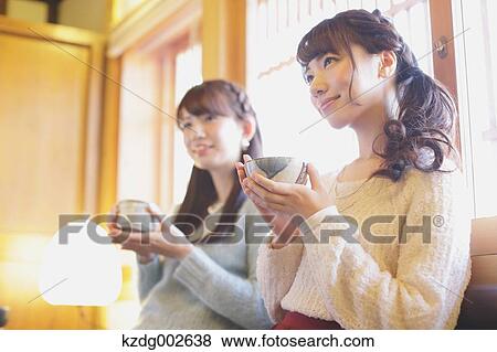 Stock Photo - Young Japanese women enjoying Maccha green tea in Kawagoe, Japan. Fotosearch