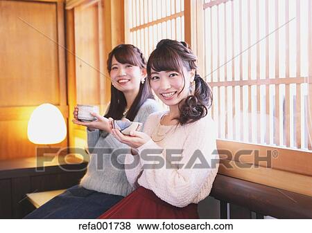 Stock Photo - Young Japanese women enjoying Maccha green tea in Kawagoe, Japan. Fotosearch