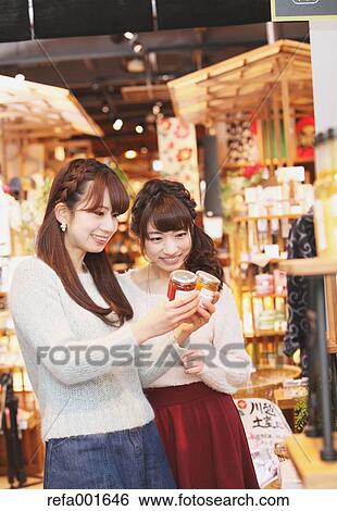 Stock Photograph - Young Japanese women enjoying shopping in Kawagoe, Japan. Fotosearch