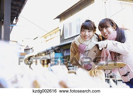Stock Photograph - Young Japanese women enjoying trip in Kawagoe, Japan. Fotosearch