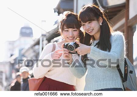 Stock Photograph - Young Japanese women enjoying trip in Kawagoe, Japan. Fotosearch