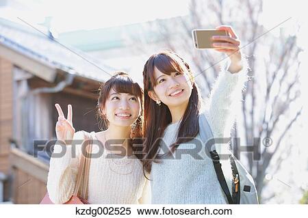 Stock Photography - Young Japanese women enjoying trip in Kawagoe, Japan. Fotosearch