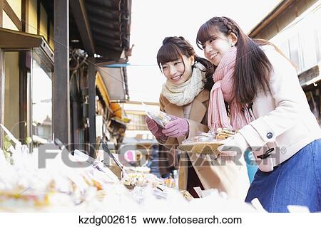 Stock Photography - Young Japanese women enjoying trip in Kawagoe, Japan. Fotosearch