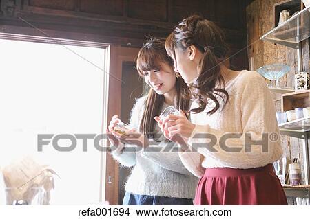 Picture - Young Japanese women enjoying visit to glass workshop in Kawagoe, Japan. Fotosearch