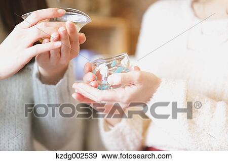 Stock Photo - Young Japanese women enjoying visit to glass workshop in Kawagoe, Japan. Fotosearch