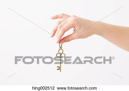 Stock Image - Young woman holding key. Fotosearch