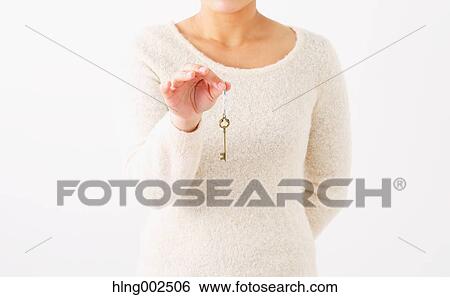 Young woman holding key View Large Photo Image Stock Photograph - Young woman holding key. Fotosearch
