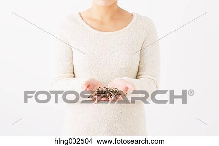 Picture - Young woman holding keys. Fotosearch