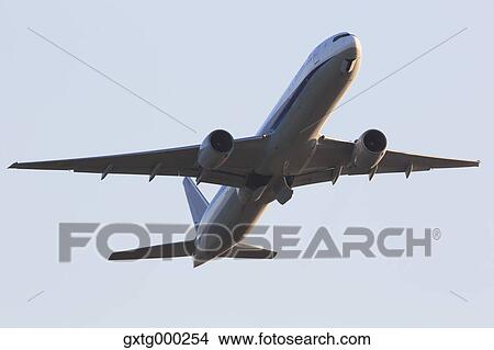 Picture - Airplane flying in the sky. Fotosearch