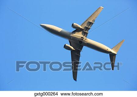Picture - Airplane flying in the sky. Fotosearch