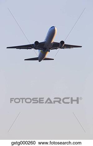 Airplane flying in the sky View Large Photo Image Stock Image - Airplane flying in the sky. Fotosearch