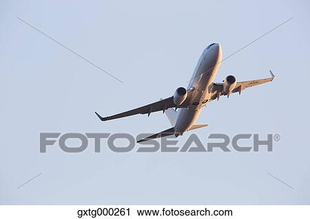 Stock Image - Airplane flying in the sky. Fotosearch