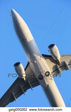 Stock Image - Airplane flying in the sky. Fotosearch