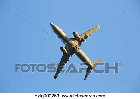 Airplane flying in the sky View Large Photo Image Stock Image - Airplane flying in the sky. Fotosearch
