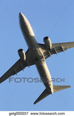 Stock Photo - Airplane flying in the sky. Fotosearch