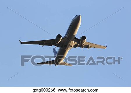 Stock Photograph - Airplane flying in the sky. Fotosearch