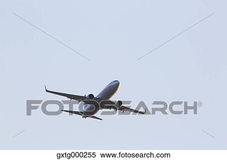 Stock Photography - Airplane flying in the sky. Fotosearch