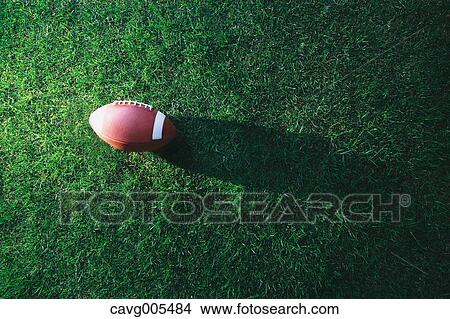 American football ball on grass View Large Photo Image Picture - American football ball on grass. Fotosearch