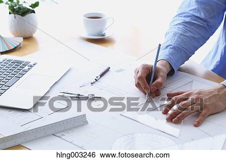 Stock Photograph - Architect working in his studio. Fotosearch