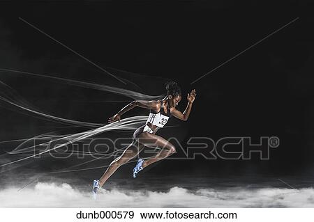 Stock Photo - Athlete running in the smoke. Fotosearch
