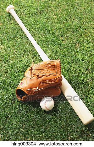 Picture - Baseball equipment on grass. Fotosearch