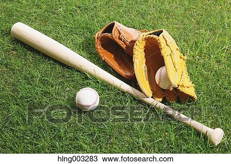 Stock Image - Baseball equipment on grass. Fotosearch