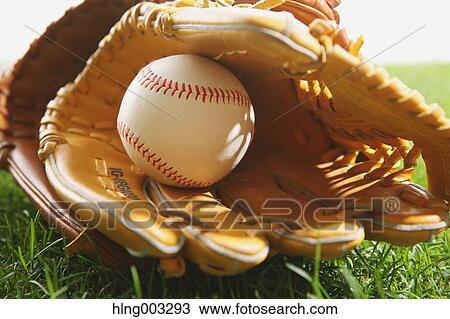 Stock Image - Baseball equipment on grass. Fotosearch