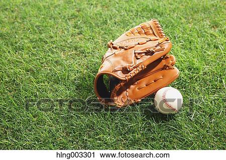 Stock Image - Baseball equipment on grass. Fotosearch