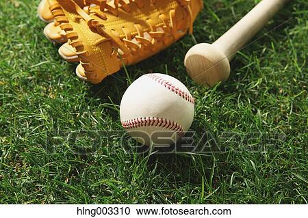 Stock Image - Baseball equipment on grass. Fotosearch