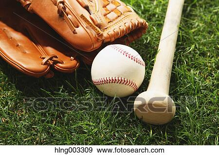 Baseball equipment on grass View Large Photo Image Stock Photo - Baseball equipment on grass. Fotosearch