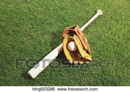 Stock Photograph - Baseball equipment on grass. Fotosearch