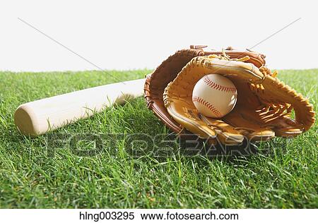 Stock Photography - Baseball equipment on grass. Fotosearch