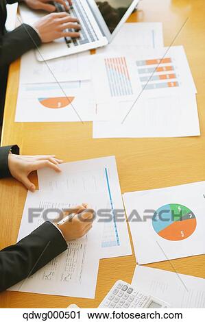 Stock Image - Business people having a meeting. Fotosearch