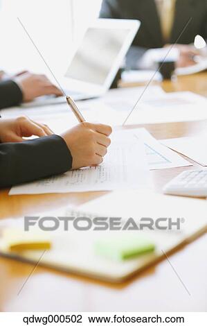 Stock Image - Business people having a meeting. Fotosearch
