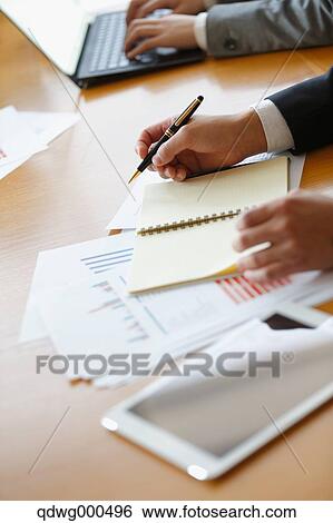 Stock Photograph - Business people having a meeting. Fotosearch