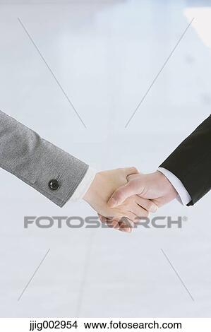 Picture - Business people shaking hands. Fotosearch