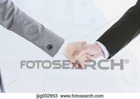 Stock Image - Business people shaking hands. Fotosearch
