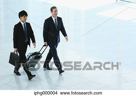 Businessmen at the airport View Large Photo Image Picture - Businessmen at the airport. Fotosearch