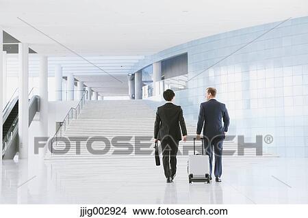 Picture - Businessmen at the airport. Fotosearch