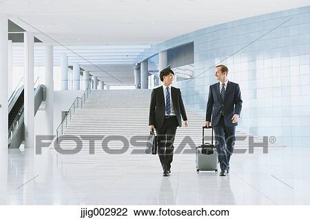 Stock Image - Businessmen at the airport. Fotosearch