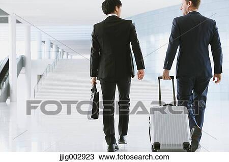 Stock Image - Businessmen at the airport. Fotosearch